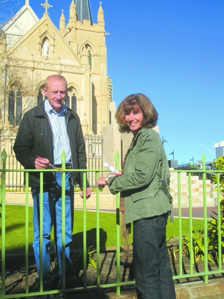 Nicholas Donnelly and Sandy Toop put some of the final licks of paint on St Mary’s Cathedral fence after months of work.
