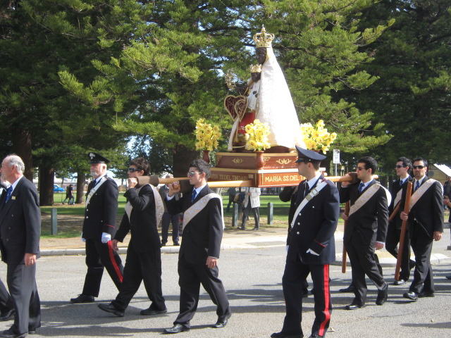 Pole bearers processing with the statue of the Black Madonna