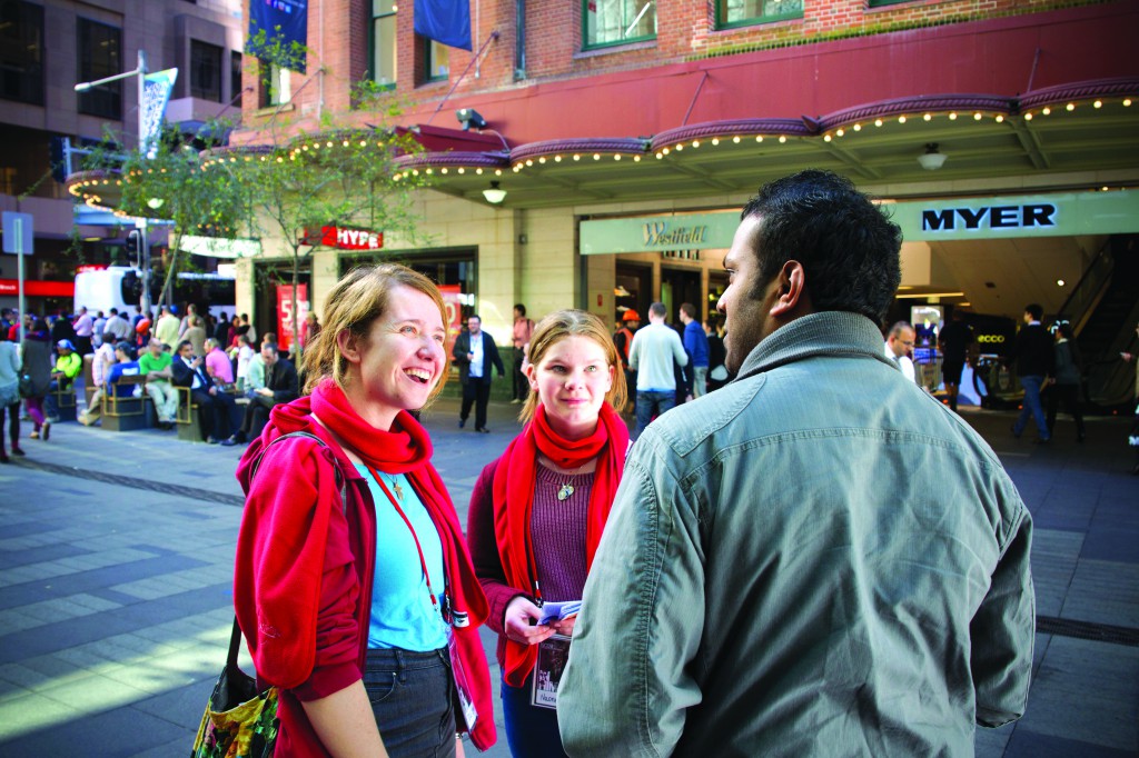 Sydney Catholic youth talk to a passer-by in the middle of Sydney central business district. PHOTO: Patrick Lee