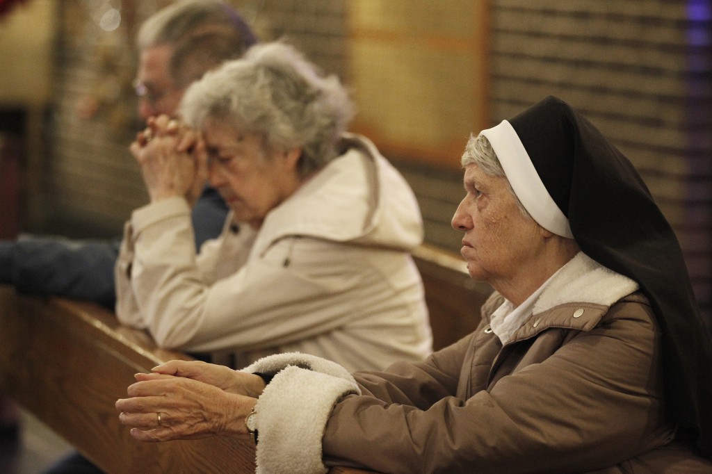 Dominican Sister Jeanine Conlon prays during a Nov. 7 Mass dedicated to people affected by Hurricane Sandy at St. Charles Church in New York's Staten Island.