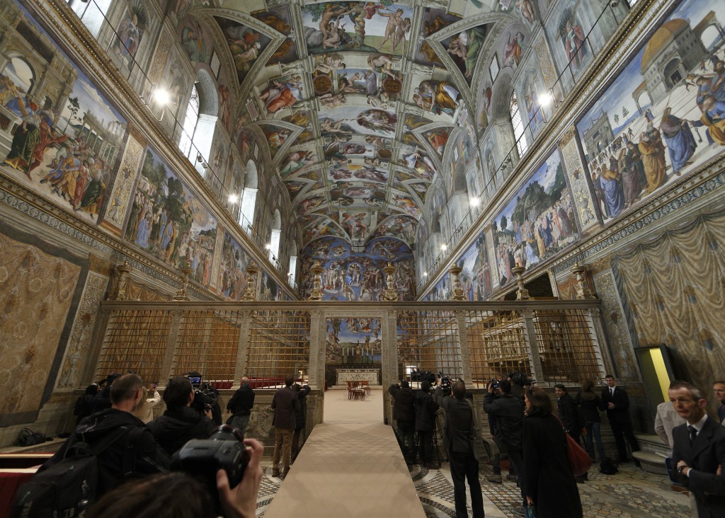 Members of the media preview the Sistine Chapel as preparations continue for the conclave March 9 at the Vatican. Cardinal electors will enter the chapel in the afternoon March 12 to begin the conclave to elect the new pope. PHOTO: CNS/Paul Haring