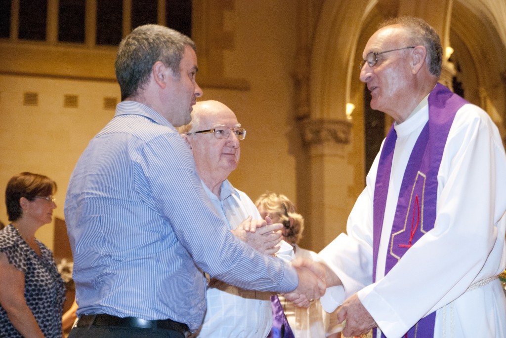 Mgr Tim Corcoran welcomes a candidate preparing to enter the Catholic Church as Mr Hugh Ryan, looks on. PHOTO: Matthew Biddle