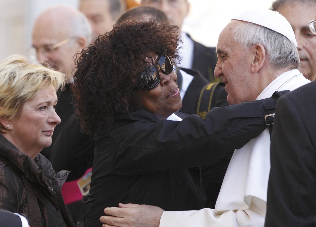 Patience Dodo of Gabon, who is blind, hugs Pope Francis on April 10 as he leaves leads his general audience in St. Peter's Square at the Vatican. PHOTO: CNS/Paul Haring