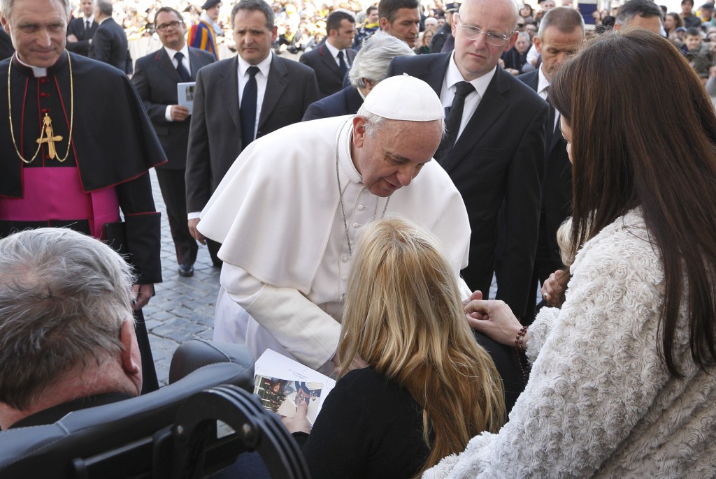 Pope Francis greets people in wheelchairs as he leaves his general audience on April 10 in St. Peter's Square at the Vatican. PHOTO: CNS/Paul Haring