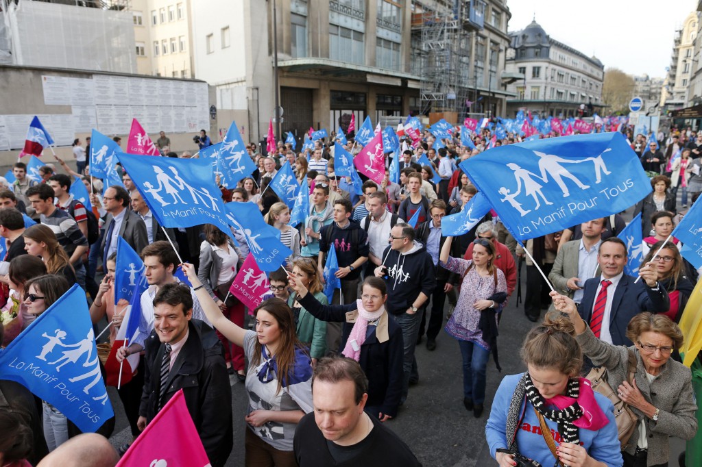 People wave banners as they demonstrate on April 17 against France's planned legalization of same-sex marriage in Paris. PHOTO: CNS/Benoit Tessier, Reuters