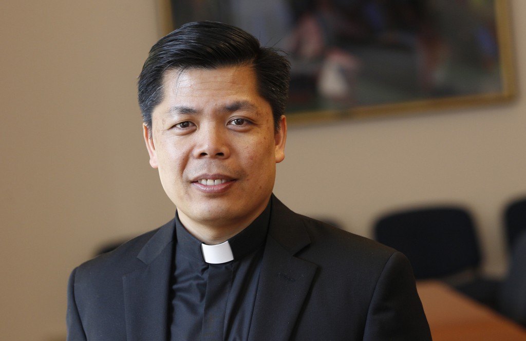 Father Peter Bui, a priest of the Diocese of Phoenix currently serving at the Pontifical Council Cor Unum, is pictured at the Vatican April 17. The council assists the pope in carrying out humanitarian initiatives throughout the world. PHOTO: CNS/Paul Haring 