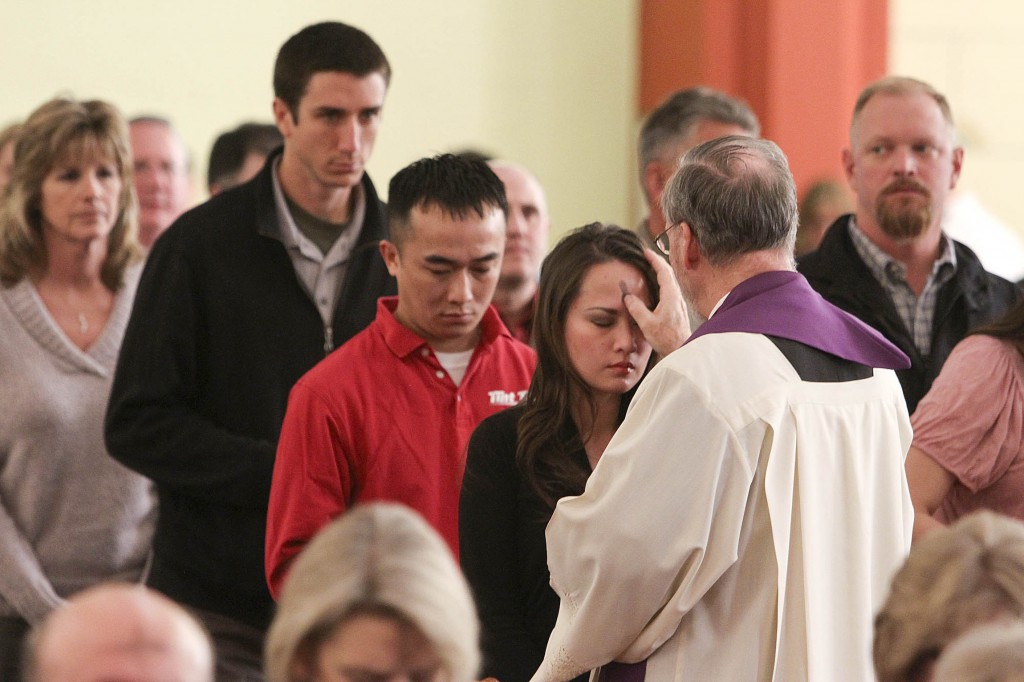 Woman recives ashes from priest during 2012 Ash Wednesday service at Oklahoma church