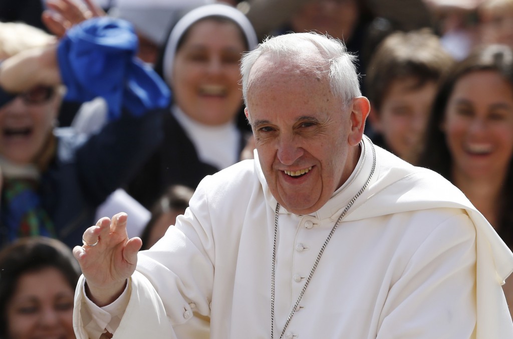 Pope Francis greets the crowd as he arrives to lead his general audience in St. Peter's Square at the Vatican May 22. PHOTO: CNS/Paul Haring