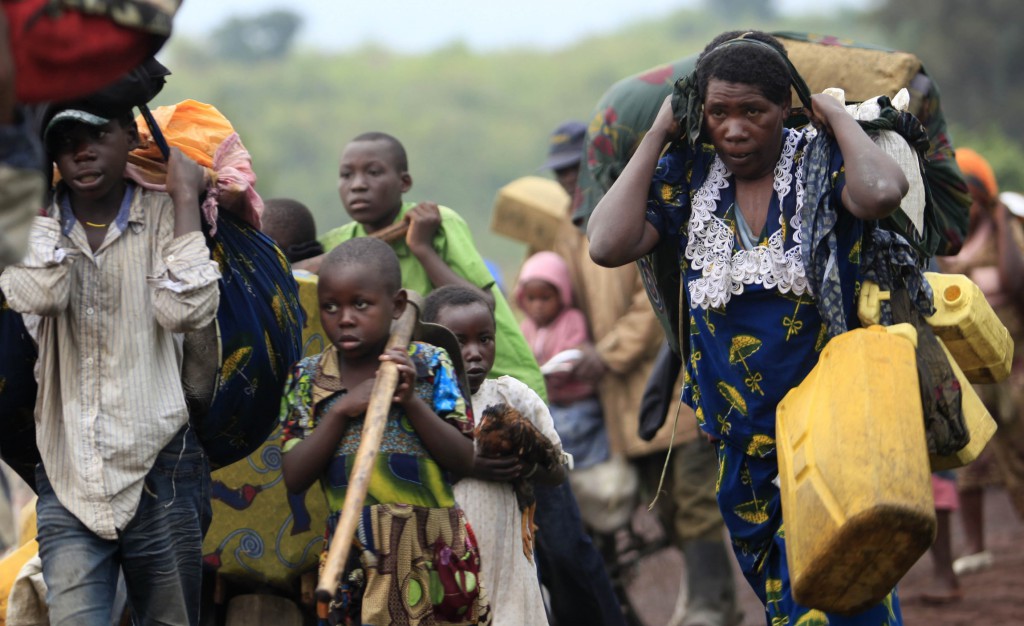 Families fleeing renewed fighting between the Democratic Republic of the Congo army and rebels walk on July 24 toward the eastern city of Goma. PHOTO: CNS/James Akena, Reuters