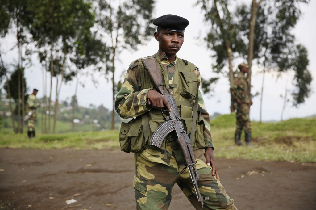 A fighter stands guard on Nov. 28, 2012 as Congolese rebels prepare to withdraw from Karuba, near Goma, Congo. PHOTO: CNS/Goran Tomasevic, Reuters)