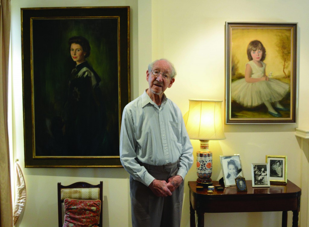 Paul Fitzgerald AM, photographed at home and in front of his famous portrait of Her Royal Majesty, Queen Elizabeth II. Photo: Fiona Basile/Kairos