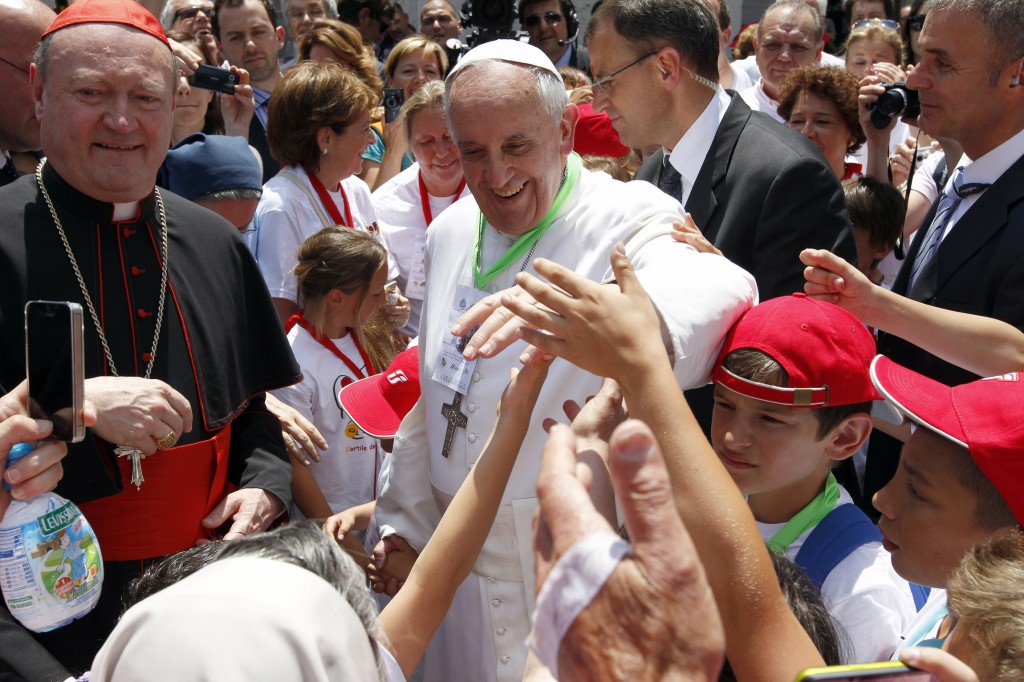 Pope Francis smiles as he welcomes more than 250 children who traveled on a special train from Milan, Italy, to meet him at the St. Peter train station on June 23 in the Vatican. PHOTO: CNS/Giampiero Sposito, Reuters