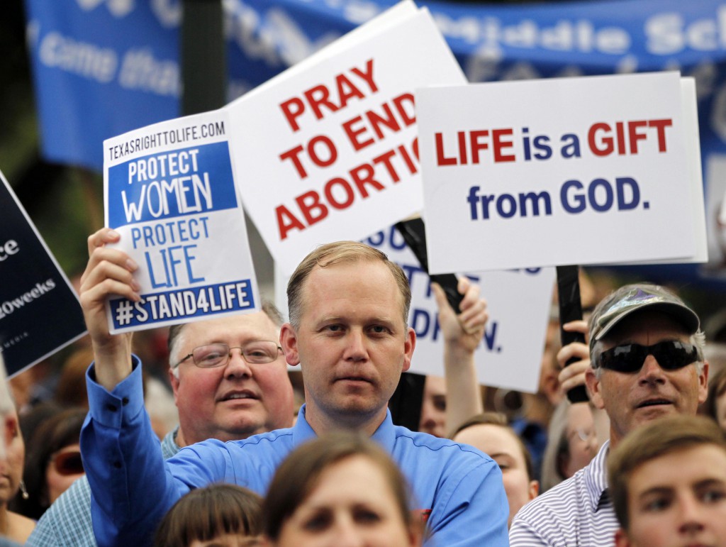 Protesters hold signs during an anti-abortion rally at the Texas Capitol in Austin July 8 as the Legislature continued to debate in special session a measure that would ban abortions after 20 weeks of gestation and place new restrictions on abortion providers. PHOTO: CNS/Mike Stone, Reuters