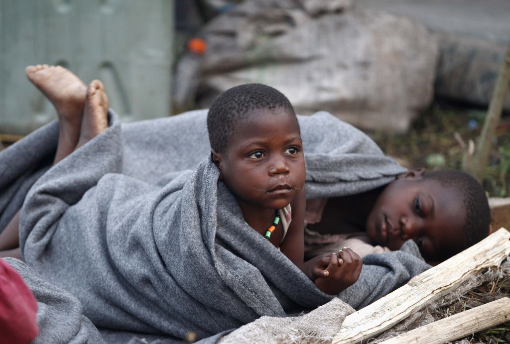 Congolese children displaced by fighting between the Congo army and the rebel group Allied Democratic Forces rest in the open at the Bukanga transit camp in Bundibugyo, Uganda. PHOTO: CNS/James Akena, Reuters