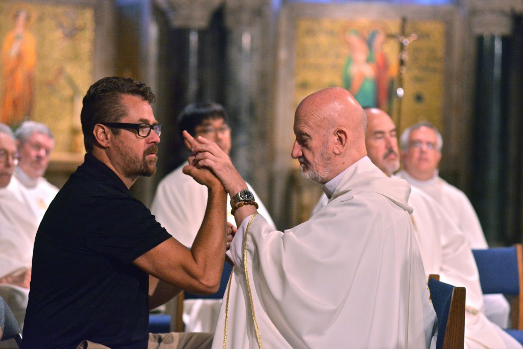 Redemptorist Father Cyril Axelrod of London, right, who is both deaf and blind, participates in a July 16 Mass in the crypt church of the Basilica of the National Shrine of the Immaculate Conception, assisted by David Day, during a gathering of the International Catholic Deaf Association in Washington. PHOTO: CNS/Michael Hoyt, Catholic Standard