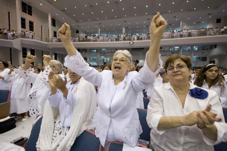 Congregation member Bertha Salva (2L) cheers the speech by Democratic presidential hopeful New York Senator Hillary Rodham Clinton at the Congregation Mita en Aaron Protestant Church in San Juan, Puerto Rico on May 31, 2008. (Robyn Beck/AFP/Getty Images)