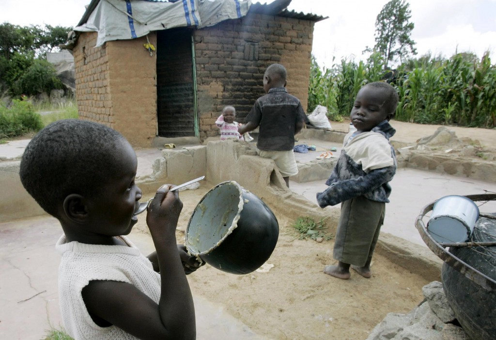 A girl eats outside her home in the Harare suburb of Epworth, Zimbabwe in 2009. PHOTO: CNS