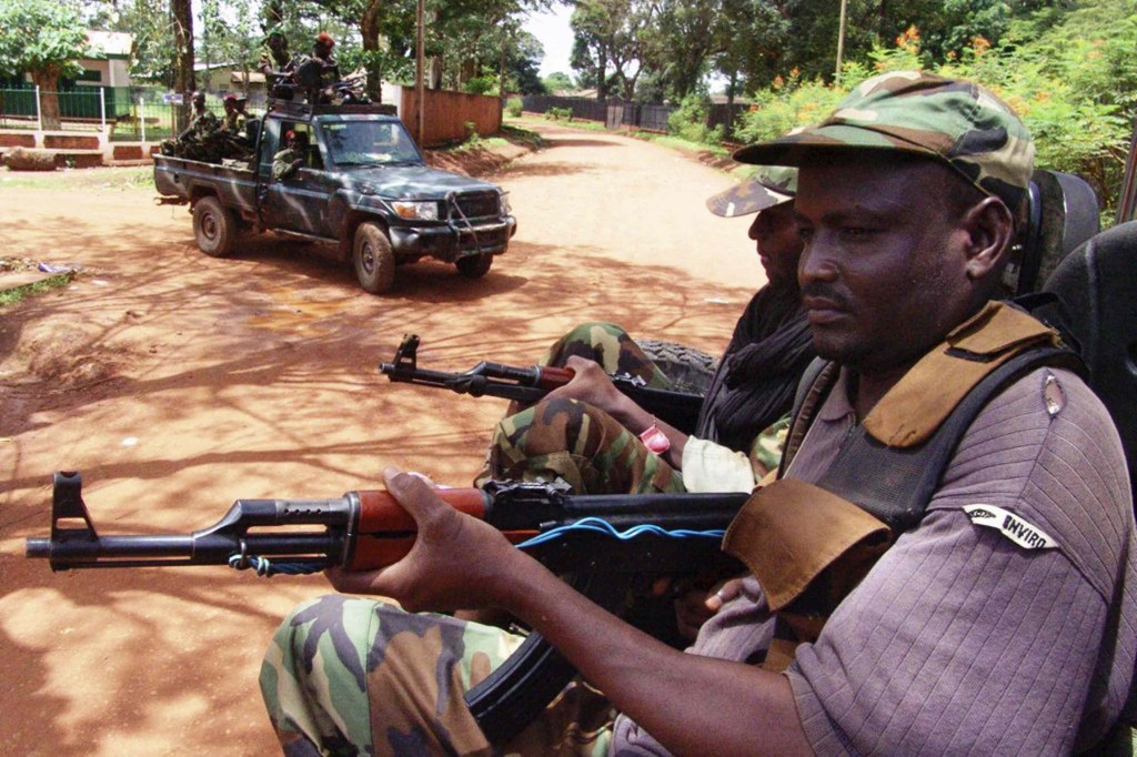 Armed rebel fighters calling themselves Seleka ("Alliance") patrol the streets in pickup trucks to stop looting in Bangui, Central African Republic, March 26.  In an email and in a telephone interview with Catholic News Service, Father Gazzera said the Aug. 13 Independence Day prayers had taken place in a "sad atmosphere" in local villages, where thousands had fled to escape violent looting by members of an Islamist-led rebel Seleka alliance, which occupied much of the country last spring. PHOTO: CNS/Alain Amontchi, Reuters