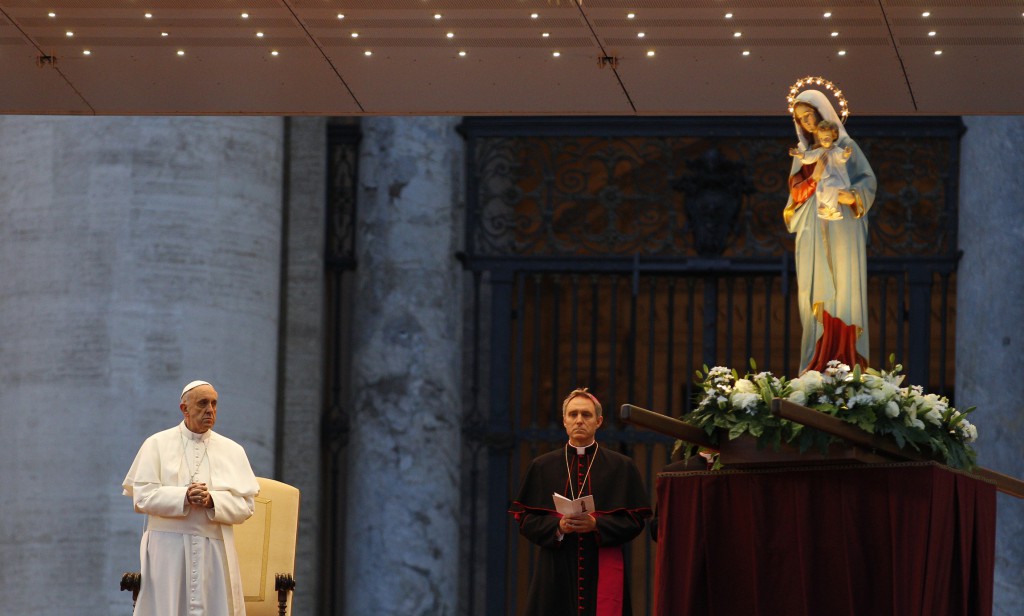 A statue of Mary and Jesus is seen as Pope Francis leads a Marian prayer service on May 31 in St. Peter's Square at the Vatican.  "This is the time for mercy," Pope Francis told reporters July 28 during his flight back to Rome from Brazil. "The church is mother and must follow the path of mercy, and find mercy for everyone." 