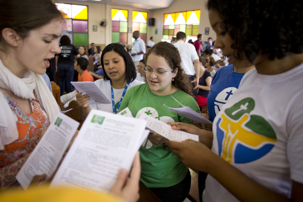 World Youth Day volunteers sing with others at St. Michael's Chapel in Rio de Janeiro in April. PHOTO: CNS/Elie Gardner