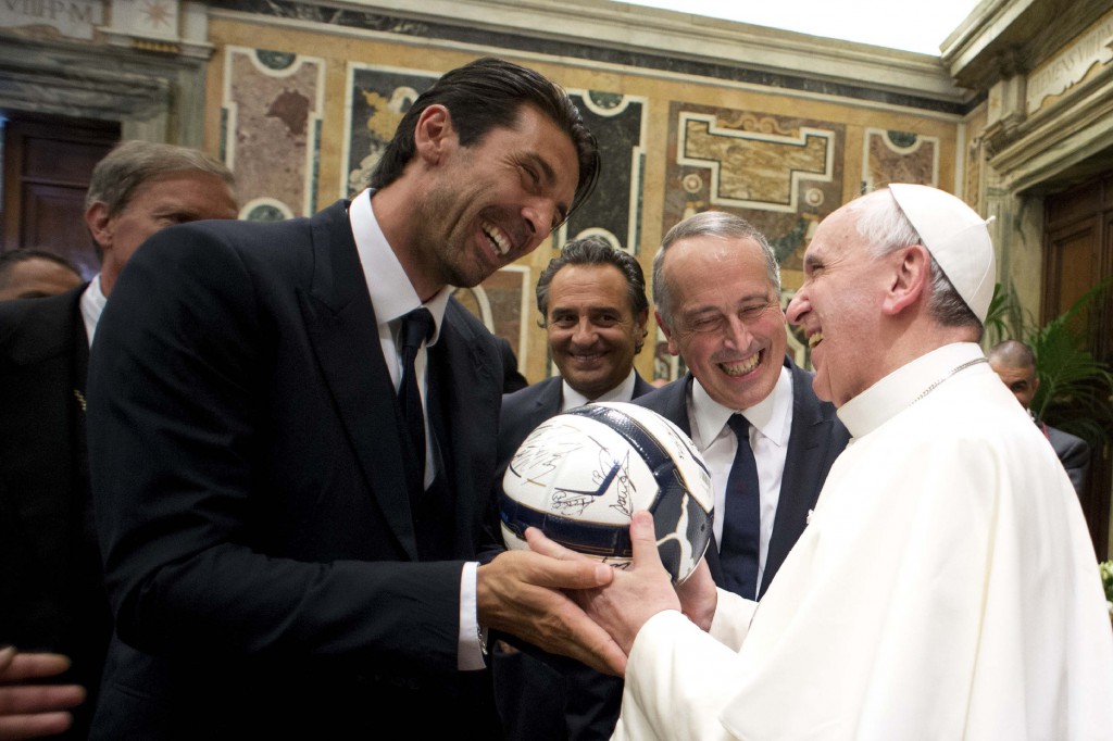 Pope Francis receives a soccer ball as gift from Italy's goalkeeper and captain, Gianluigi Buffon, during a private audience at the Vatican Aug. 13. Argentina will play Italy in a friendly soccer match Aug. 14 in the pope's honour. PHOTO: CNS/L'Osservatore Romano via Reuters