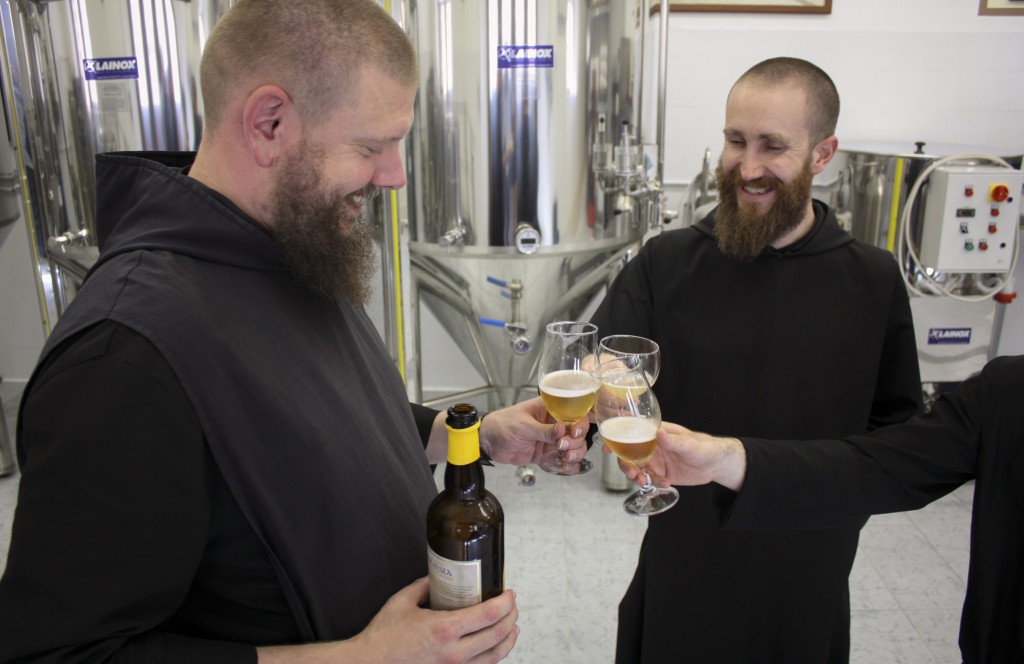 Benedictine Brother Francis Davoren, left, head "brewmonk" or brewmaster, and Benedictine Father Benedict Nivakoff, director of Birra Nursia, toast with their blond brew Aug. 14 at the brewery of St. Benedict's Monastery in Norcia, Italy. PHOTO: CNS/Henry Daggett