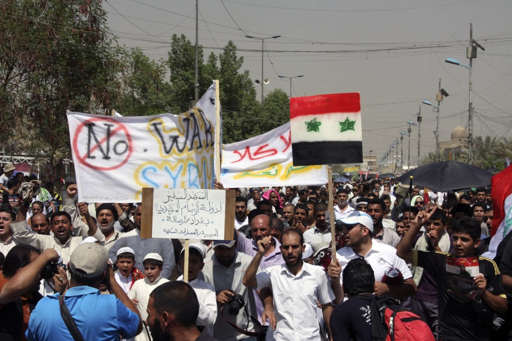 Iraqis in Baghdad demonstrate Aug. 30 against the possibility of a U.S. military strike against the Syrian government. As speculation mounted about air strikes on Syria, Western church leaders warned military intervention could lead to an escalation of hostilities. PHOTO: CNS/Kareem Raheem, Reuters