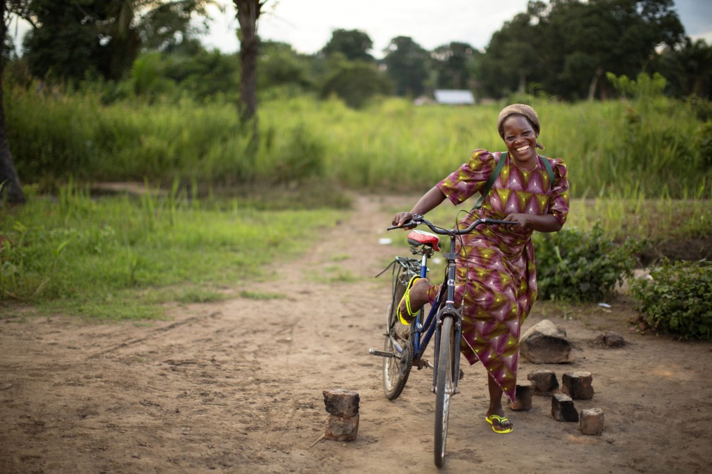 Sister Angelique Namaika, a member of the Augustine Sisters of Dungu and Doruma, smiles while getting on her bicycle Aug. 1 in Congo. Sister Angelique received the 2013 Nansen Refugee Award from the U.N. High Commissioner for Refugees Sept. 17 for her work with women forced to leave their homes in northeastern Congo because of long-term civil strife. PHOTO: CNS/Brian Sokol, courtesy UNHR