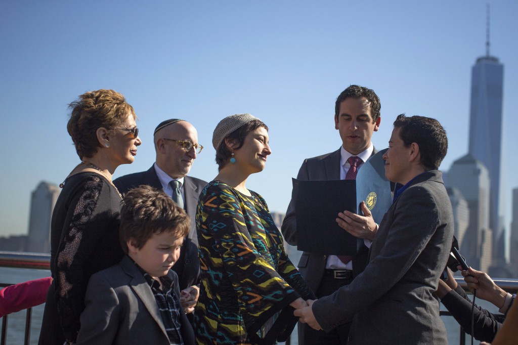 Meredith Greenberg holds hands with her partner, Leora Pearlman, at their wedding on Oct. 21 in Jersey City. The ACT has become the first jurisdiction in Australia to legalise same-sex marriage after the bill passed the territory’s Legislative Assembly on October 22. PHOTO: CNS/Shannon Stapleton, Reuters