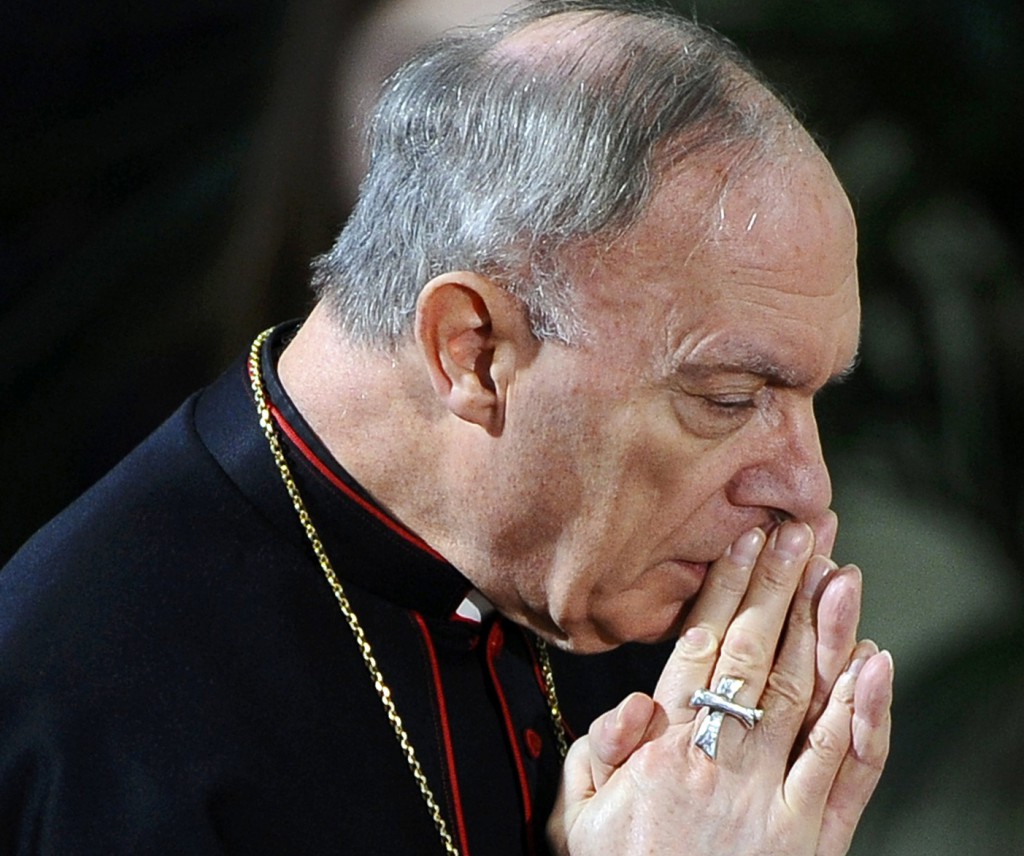 Belgian Archbishop Andre-Joseph Leonard of Mechelen-Brussels prays during a March 22 Mass at St. Peter's Church in Leuven for some of the victims of a bus crash in Switzerland. Archbishop Leonard, president of the Belgian bishops' conference, joined other faith leaders who criticized proposed legislation to extend euthanasia to children and dementia sufferers, warning the measure risks "destroying the functioning of society." PHOTO: CNS/Benoit Doppagne Yorick Jansens, pool via Reuters