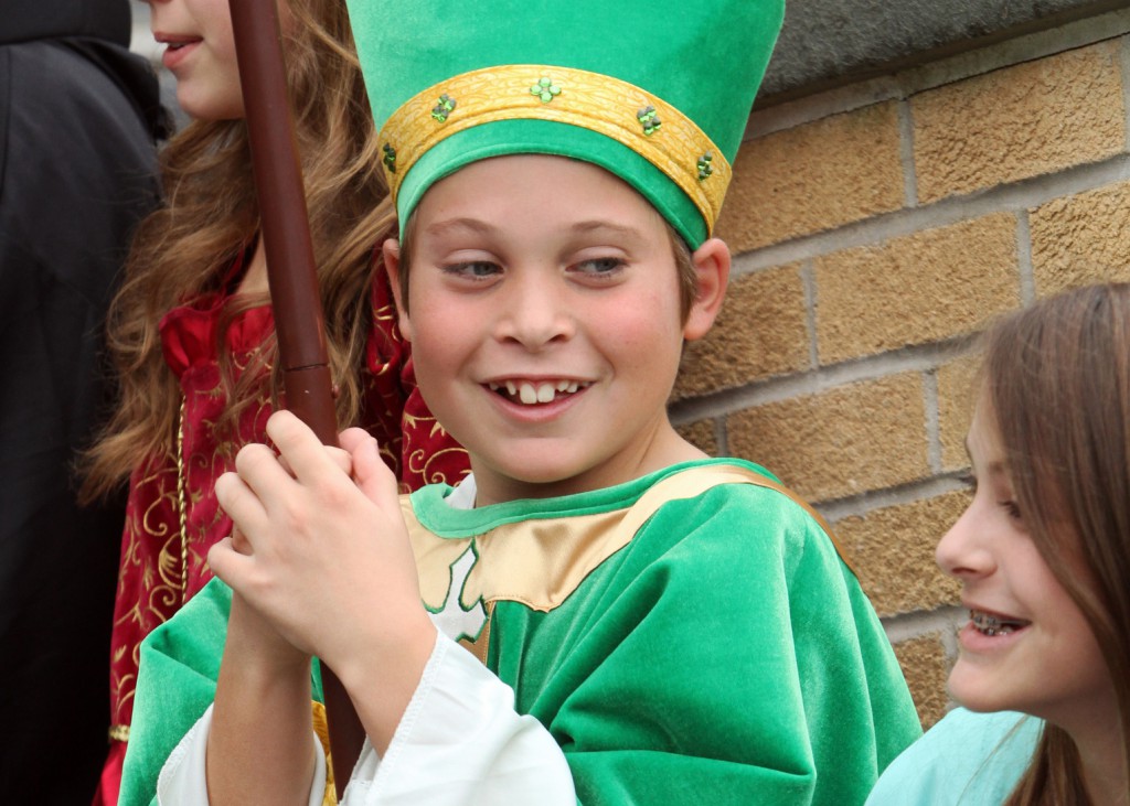 Timothy O'Leary, dressed as St. Patrick, smiles as he gathers with his classmates on Oct. 31 after Mass at Sts. Philip and James Church in St. James, N.Y. Sixth-graders in the parish school participate annually in a saints' pageant in commemoration of All Saints' Day, Nov. 1. Moving four candidates closer to beatification, Pope Francis recognized the martyrdom of a bishop in communist-controlled Romania and the heroic virtues of three religious women: one born in the United States, one Irish and one Italian. PHOTO: CNS/Gregory A. Shemitz