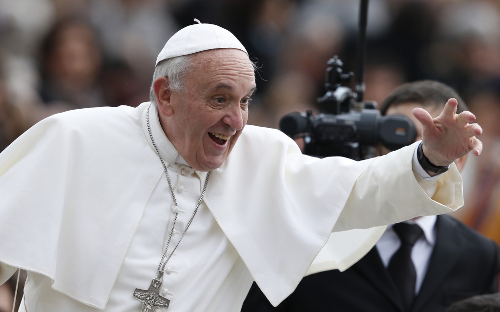 Pope Francis greets people as he arrives on  Nov. 13 to lead his general audience in St. Peter's Square at the Vatican. PHOTO: CNS/Paul Haring