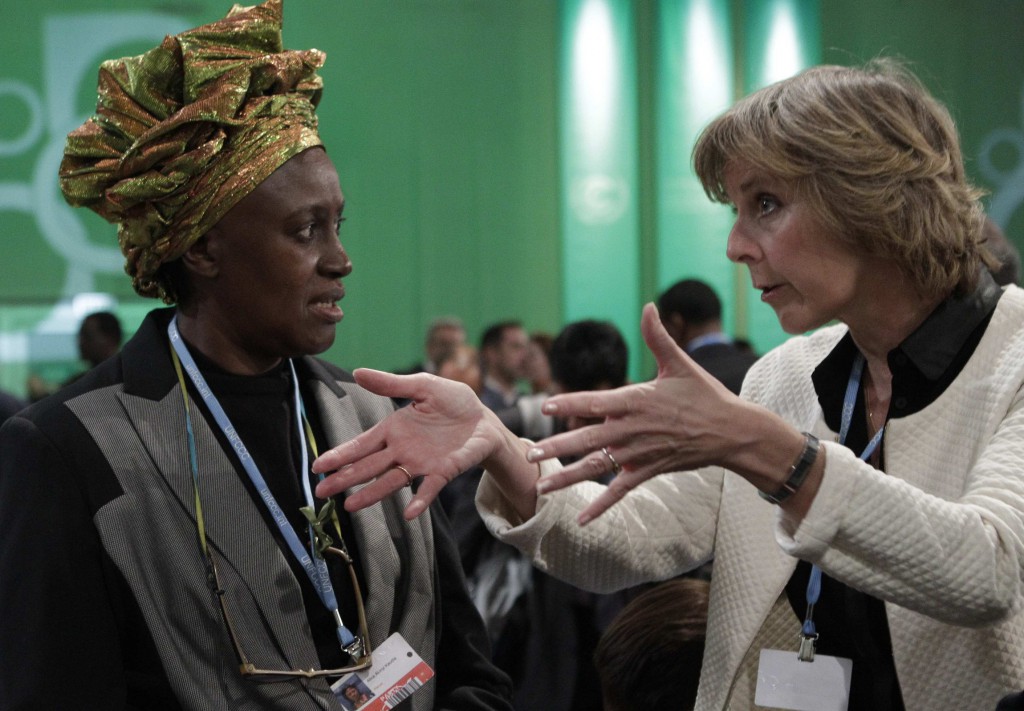 Connie Hedegaard, European commissioner for climate action, right, talks with Kenyan delegate Alice Akinyi Kaudia as they attend the Conference of Parties of the U.N. Framework Convention in Warsaw, Poland, Nov. 19. Hedegaard told a separate church-run conference she believed churches had a role to play in recalling the "forgotten spiritual dimension" underlying economic development. PHOTO: CNS/Kacper Pempel, Reuters