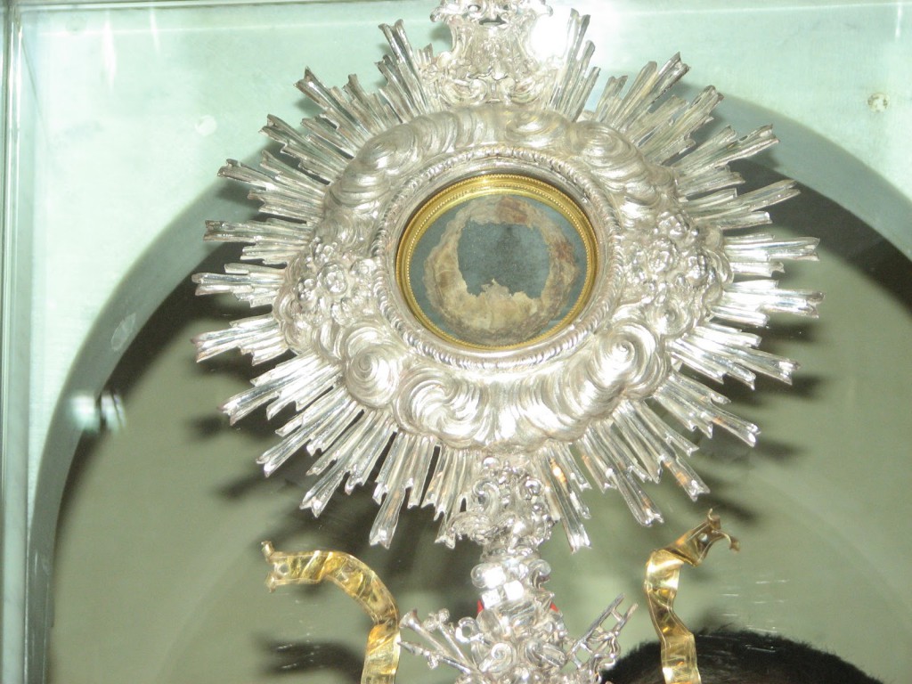 This is a photograph of the Miracle Host of the real Flesh of Jesus Christ which has been preserved in a monstrance for all to see and venerate in a church in Lanciano, Italy where the Eucharistic miracle happened in the year 700 A.D., some 1,312 years ago.