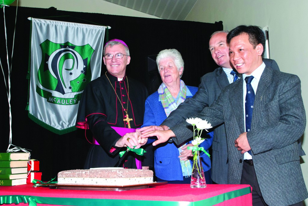 Archbishop Timothy Costelloe SDB, Sr Joan Kelleher, Dr Tim McDonald and Fr Son Nguyen prepare to cut the centenary cake. Almost 1,000 people attended St Michael’s centenary celebrations on May 24. PHOTO: Mathew Biddle