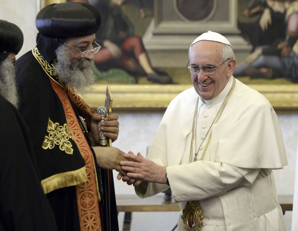 Pope Tawadros II of Alexandria, patriarch of the Coptic Orthodox Church, and Pope Francis shake hands after exchanging gifts during a private audience in the pontiff's library at the Vatican May 10, 2013. PHOTO:" CNS/Andreas Solaro, pool via Reuters