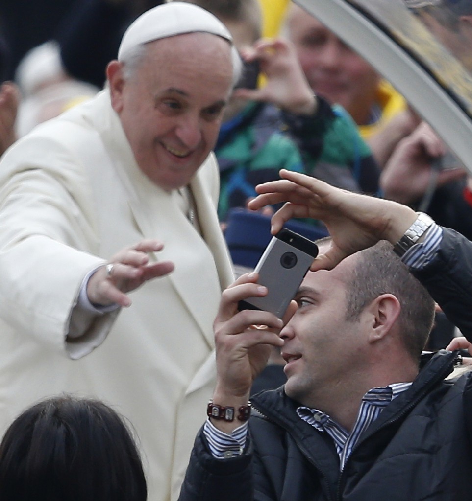 A man takes a "selfie" of himself and Pope Francis as the pope arrives for his general audience in St. Peter's Square at the Vatican Jan. 22. PHOTO CNS/Paul Haring