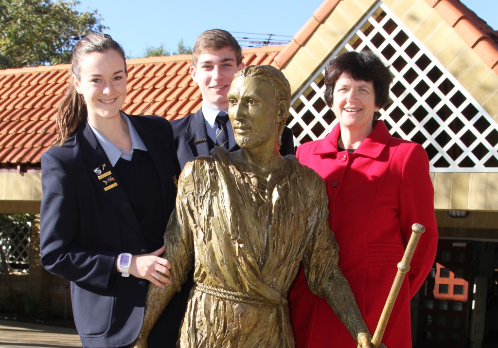 John XXIII College principal Anne Fry, head girl Hannah Cadlolo and head boy Dominic Guerrera with the new sculpture  of St Ignatius of Loyola, one of three sculptures dedicated to the school’s heritage.