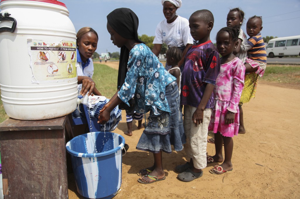 Liberian children are encouraged to wash their hands as part of an Ebola sensitization program in Monrovia, Liberia, Aug. 5. The death toll from the Ebola outbreak in Guinea, Liberia and Sierra Leone up til Aug. 6. has risen to at least 932, the World Health Organization said. PHOTO: CNS/Ahmed Jallanzo, EPA