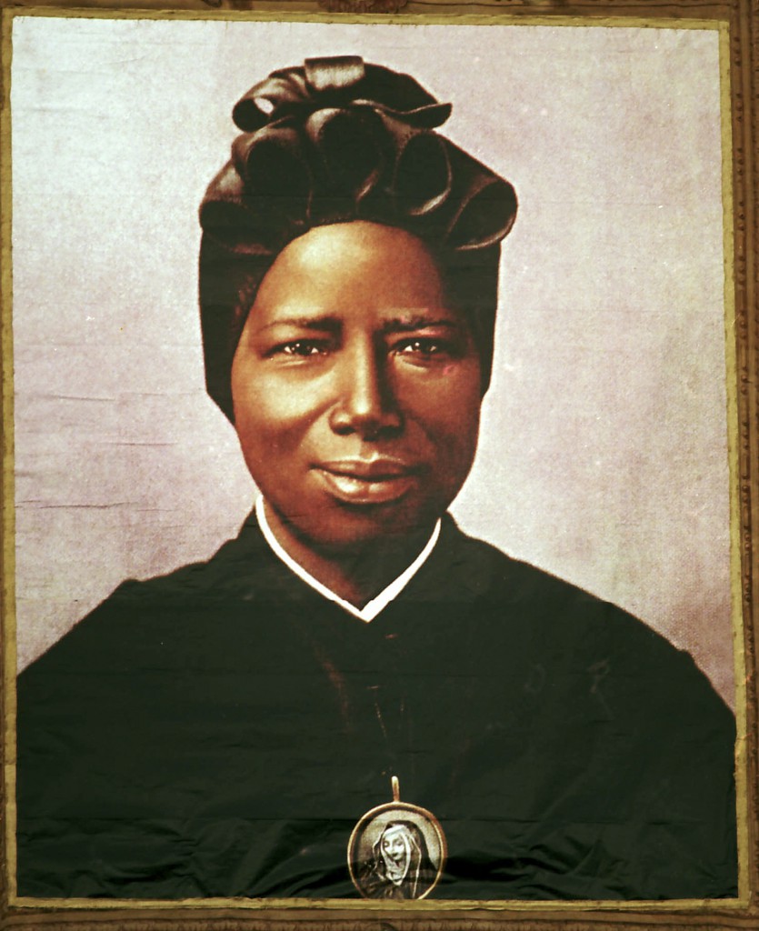 A tapestry portrait of St Josephine Bakhita, an African slave who died in 1947, hangs from the facade of St Peter's Basilica during her canonisation at the Vatican on 1 October 2000. St Bakhita has become an intercessor for Sudanese Catholics who pray for her help in ending the conflict in Darfur. St Bakhita was born in the Darfur region of what is now Sudan. PHOTO: CNS/L'Osservatore Romano via Reuters