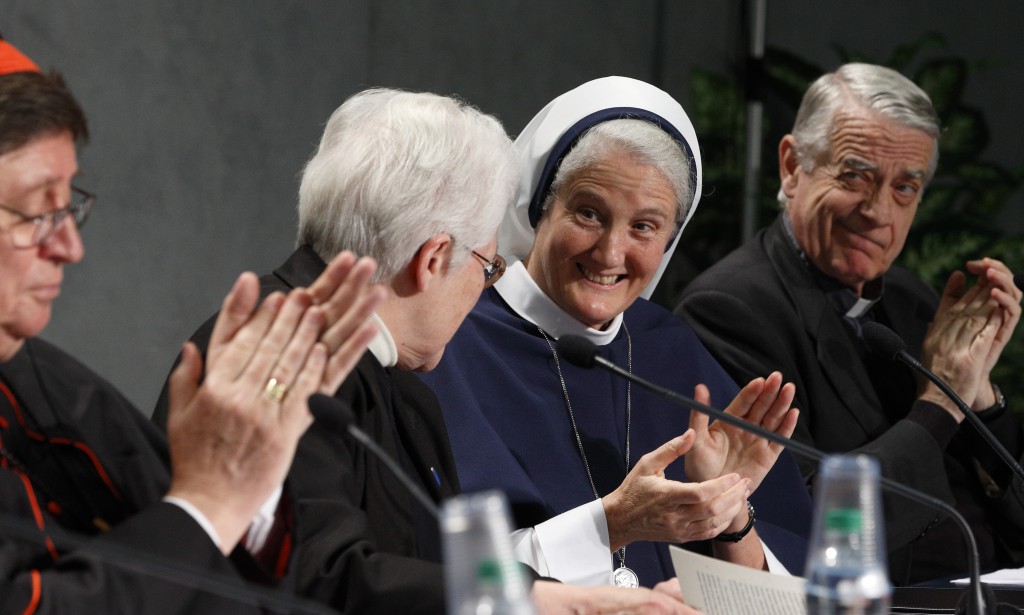 Sister Sharon Holland, president of the Leadership Conference of Women Religious, second from left, receives applause after speaking at a Dec. 16 Vatican press conference for release of the final report of a Vatican-ordered investigation of U.S. communities of women religious. PHOTO: CNS/Paul Haring