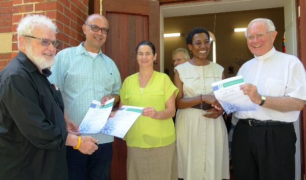 Fr Paul Pitzen from the Emmanuel Centre presents MHFA certificates to Albert, an Emmanuel Centre volunteer, and Jenny, who is profoundly deaf. Monsignor Michael Keating presents a MHFA certificate to Grace, one of his parishioners at St Mary’s Cathedral. PHOTO; Supplied