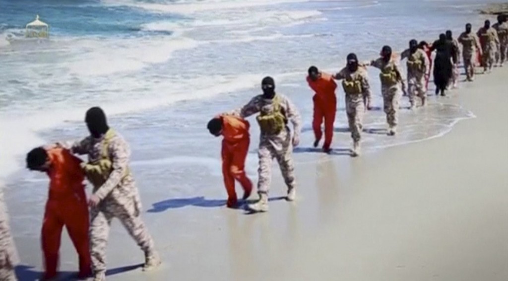 Islamic State militants lead what are said to be Ethiopian Christians along a beach in Libya in this still image from an undated video made available on a social media website April 19.PHOTO: CNS/Social Media Website via Reuters TV