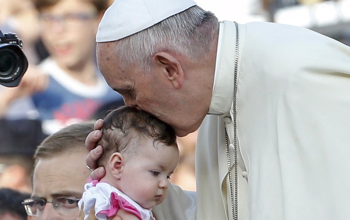 Pope Francis kisses a child during an audience for families participating in the pastoral conference of the Diocese of Rome in St. Peter's Square at the Vatican June 14. PHOTO: CNS/Giampiero Sposito, Reuters