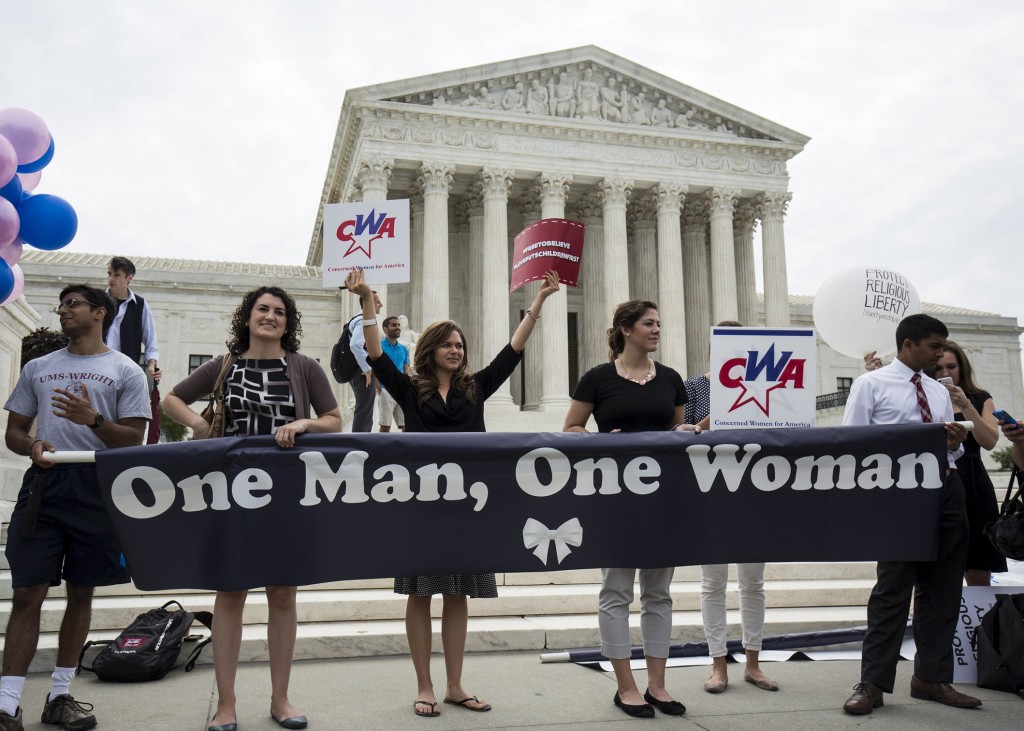 Supporters of traditional marriage between a man and a woman rally in front of the U.S. Supreme Court in Washington June 26, shortly before the justices handed down a 5-4 ruling that states must license same-sex marriages and must recognize same-sex marriages performed in other states. PHOTO: CNS/Joshua Roberts, Reuters