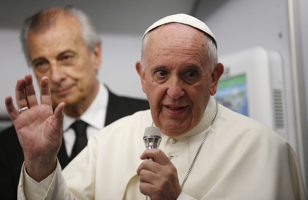 Pope Francis answers questions from journalists aboard his flight from Asuncion, Paraguay, to Rome July 12.  PHOTO: CNS/Paul Haring