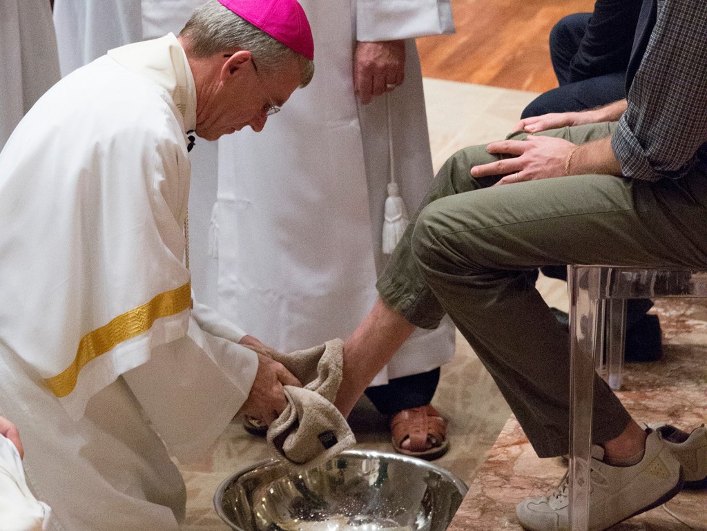 Archbishop Timothy Costelloe washes the feet of a member of the congregation at Holy Thursday Mass earlier this year. The Archbishop has this week echoed the call of Pope Francis, who called on all European parishes and religious communities to take in one refugee family as the United Nation recognises the record number of people trying to enter Europe. PHOTO: Ron Tan Photography