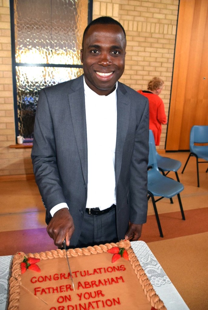 Newly ordained Fr Abraham Chukwu cuts the cake after celebrating Thanksgiving Mass at Our Lady of the Bay Parish in Busselton. Photo: Supplied.