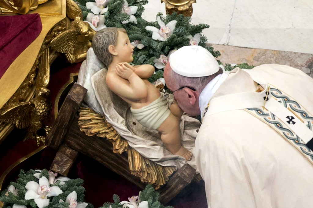 Pope Francis kisses a statue of Baby Jesus as he celebrates Mass on the feast of the Epiphany in St. Peter's Basilica at the Vatican on 6 January 205. Photo: CNS.