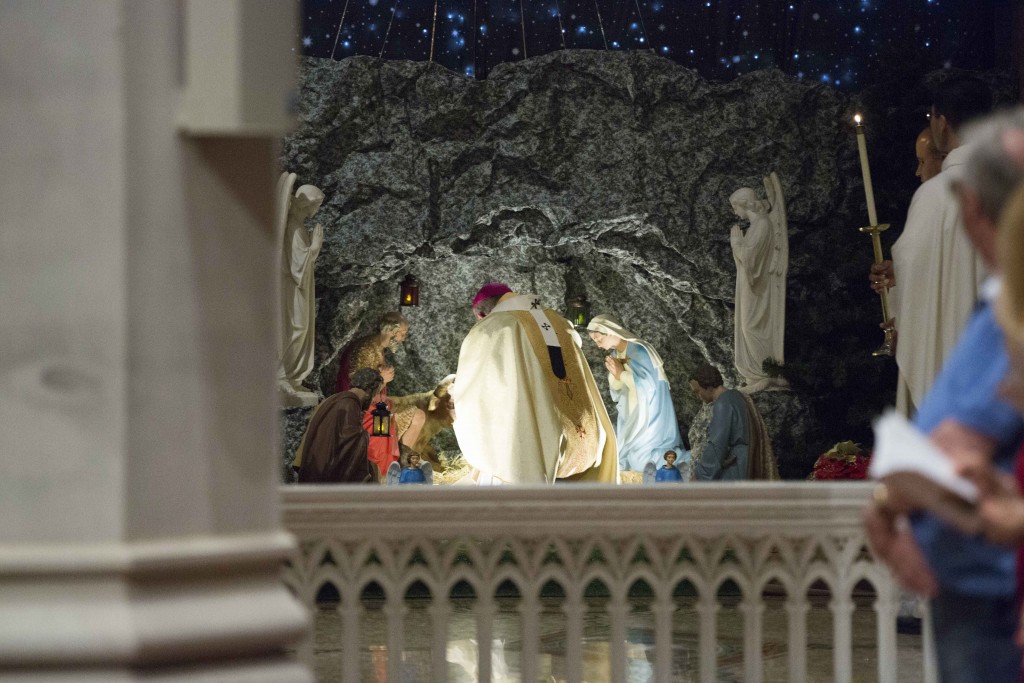 Archbishop Timothy Costelloe kneels in front of the Nativity during the Midnight Mass at St Mary’s Cathedral on Thursday 24 December 2015. The Cathedral was last month overwhelmed with visitors and regular parishioners as the local community from far and wide came together to celebrate the birth of Christ. Photo: Ron Tan.